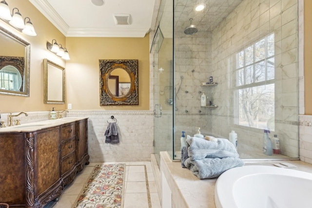 full bathroom featuring crown molding, tile walls, a stall shower, a sink, and a bath