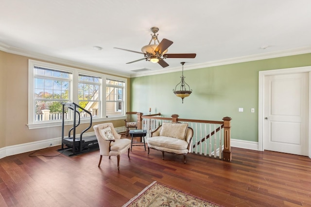 sitting room featuring crown molding, a ceiling fan, an upstairs landing, wood finished floors, and baseboards