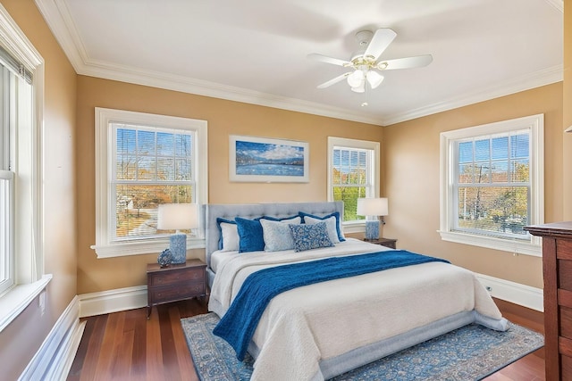 bedroom featuring ornamental molding, a ceiling fan, baseboards, and wood finished floors