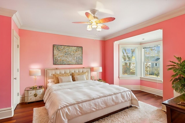 bedroom with ceiling fan, crown molding, baseboards, and wood finished floors