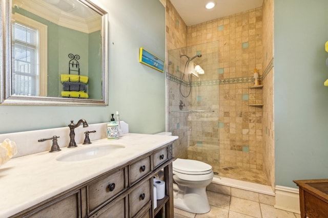 bathroom featuring a tile shower, vanity, and toilet