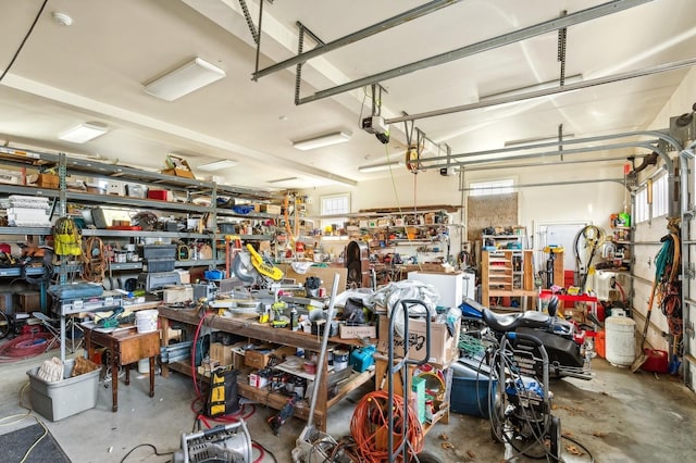 garage with a garage door opener and a workshop area