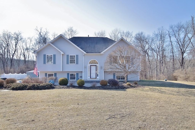 raised ranch with a front yard