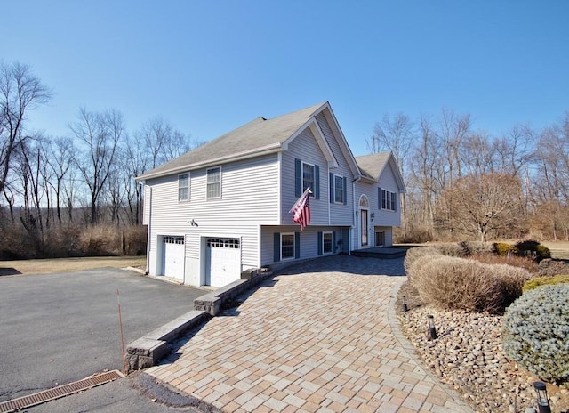 view of home's exterior featuring a garage and driveway