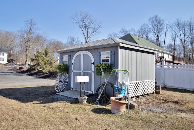 view of shed featuring fence