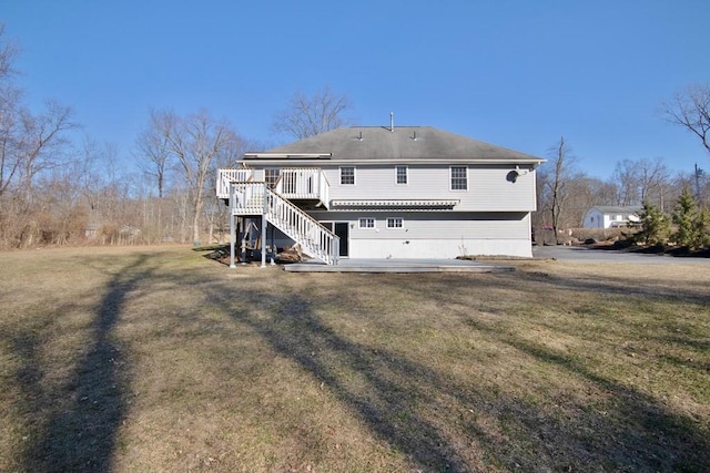 back of house featuring a wooden deck, a lawn, and stairs