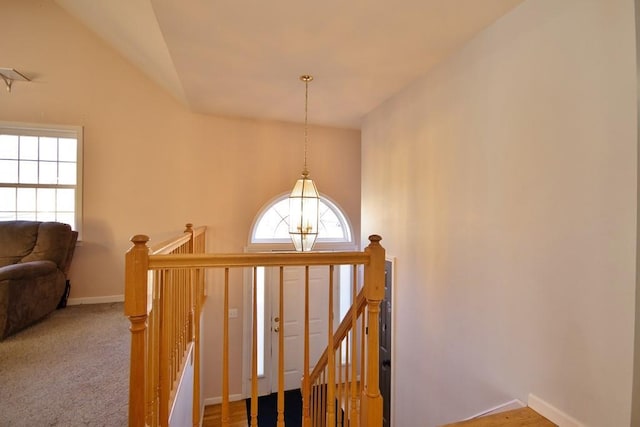 stairs with lofted ceiling, baseboards, and carpet floors