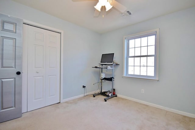 interior space with visible vents, ceiling fan, baseboards, and carpet floors