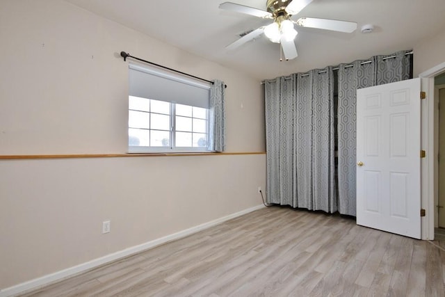 unfurnished bedroom with a ceiling fan, baseboards, and wood finished floors