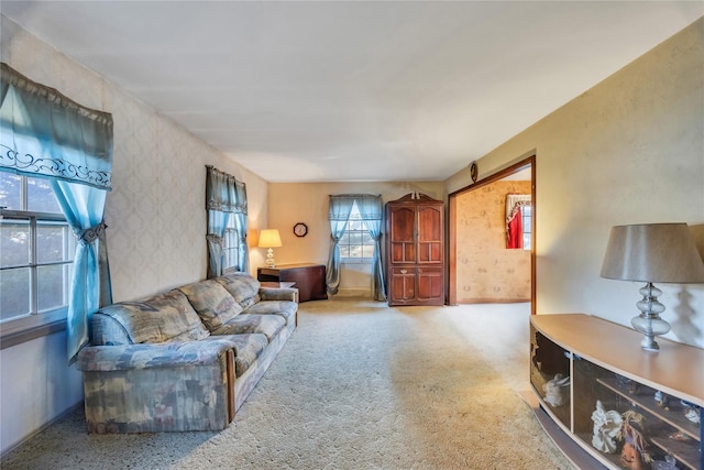 carpeted living room featuring wallpapered walls