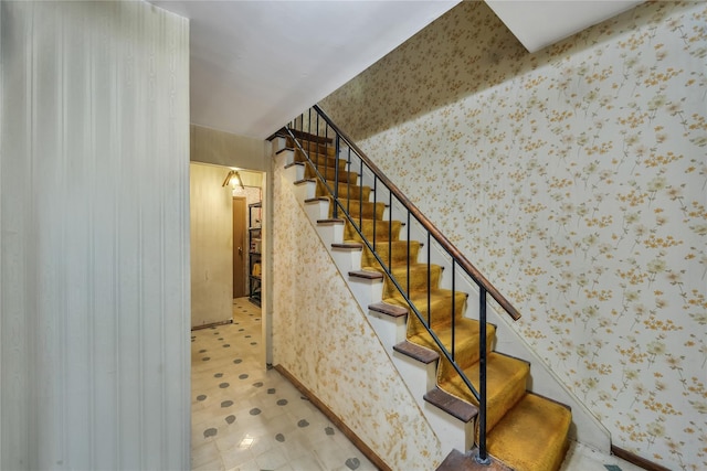 stairs with wallpapered walls