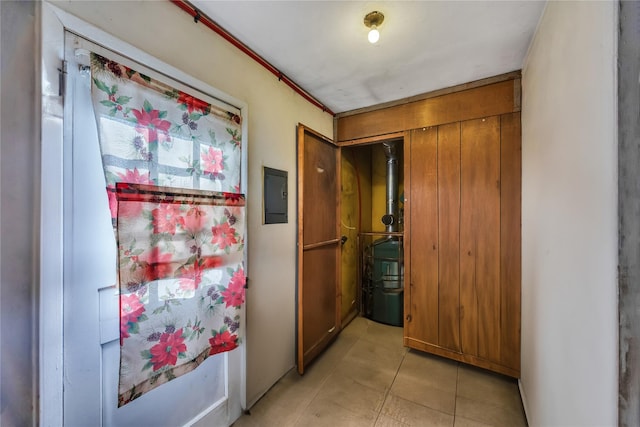 hall with electric panel and light tile patterned floors