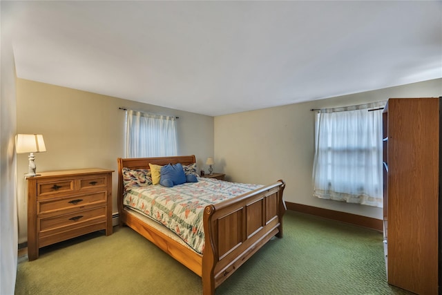 bedroom with baseboards and light colored carpet