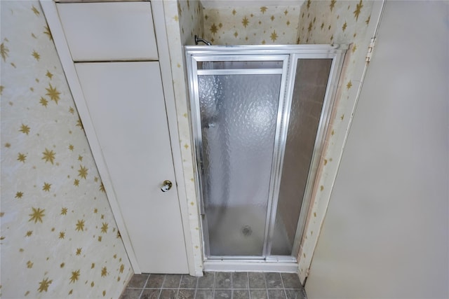 full bathroom with tile patterned floors, a shower stall, and wallpapered walls