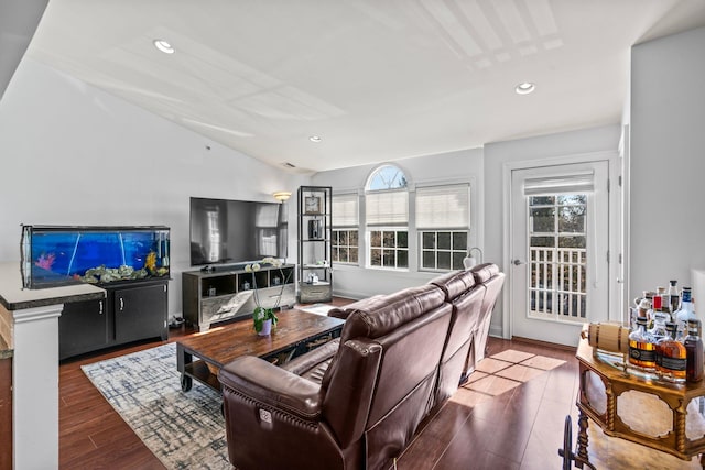 living room featuring recessed lighting, vaulted ceiling, a wealth of natural light, and wood finished floors