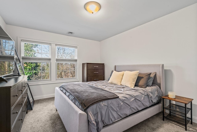 bedroom with carpet, visible vents, and baseboards