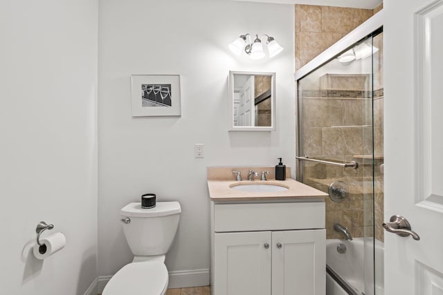 full bathroom with toilet, baseboards, combined bath / shower with glass door, and vanity