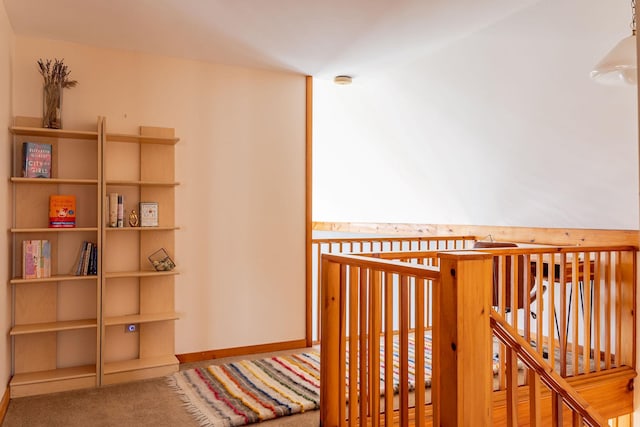 interior space featuring baseboards and carpet