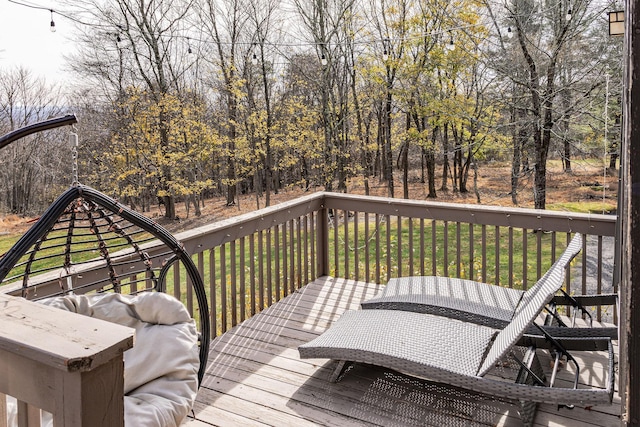 wooden deck featuring a lawn