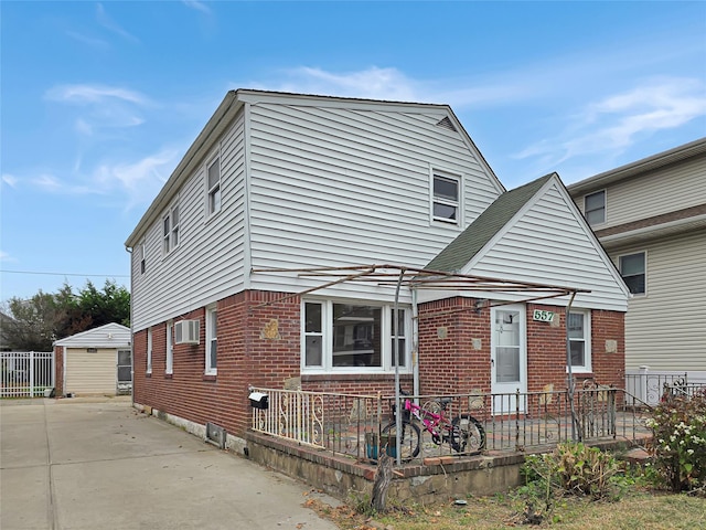 view of front facade with fence and brick siding