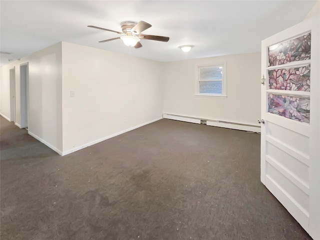 spare room with a baseboard heating unit, ceiling fan, and baseboards