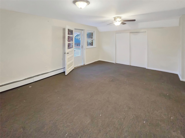 interior space featuring a baseboard heating unit, a closet, and baseboards