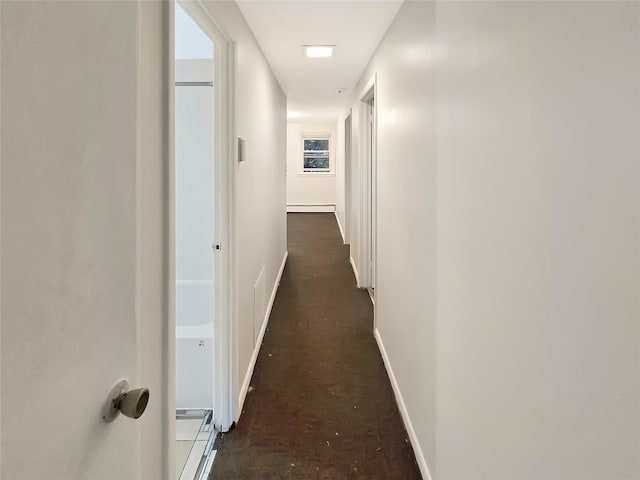 hall featuring a baseboard radiator and baseboards