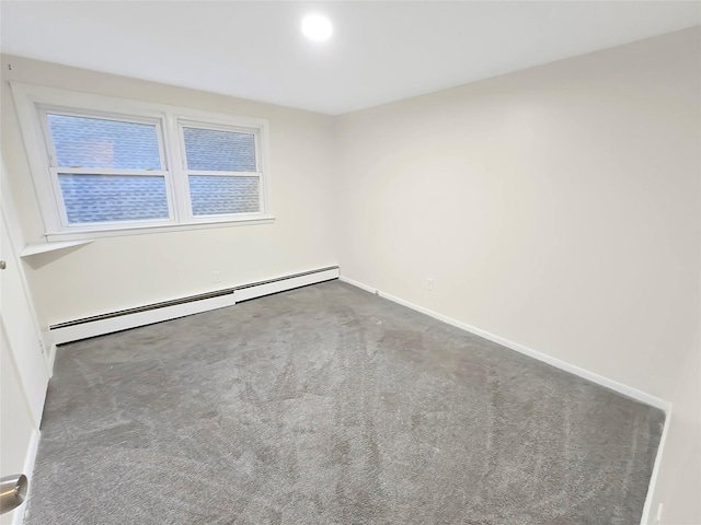 carpeted spare room featuring baseboard heating and baseboards