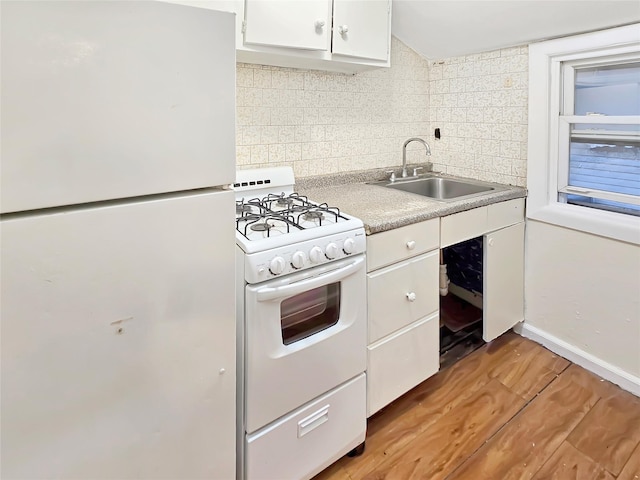 kitchen with backsplash, light wood-style floors, white cabinets, a sink, and white appliances