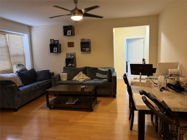 living room with ceiling fan and light wood-style floors