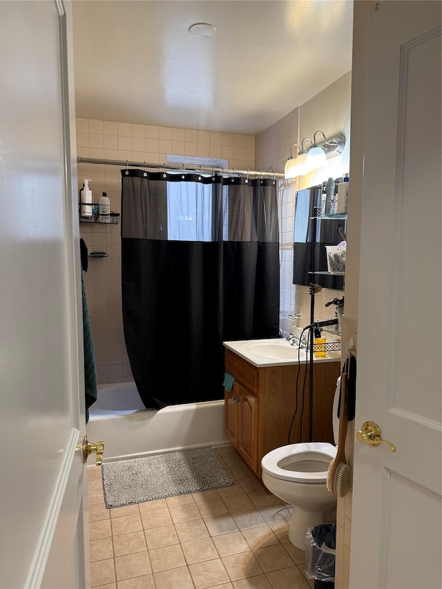 bathroom featuring vanity, tile patterned flooring, toilet, and shower / tub combo with curtain