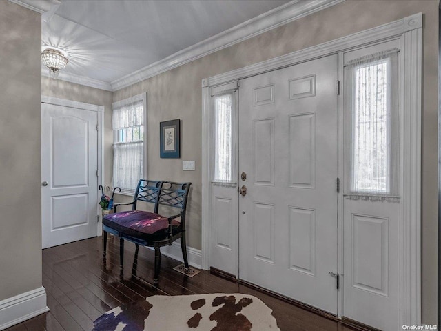 foyer entrance featuring ornamental molding, dark wood finished floors, and baseboards