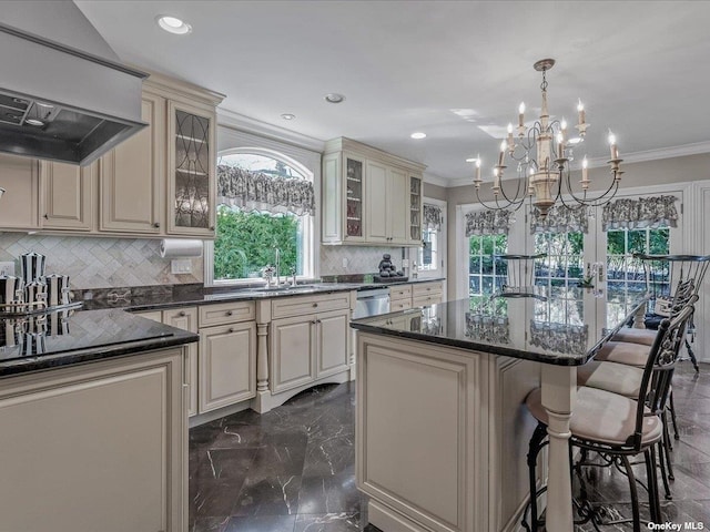 kitchen with ornamental molding, marble finish floor, custom exhaust hood, and cream cabinets