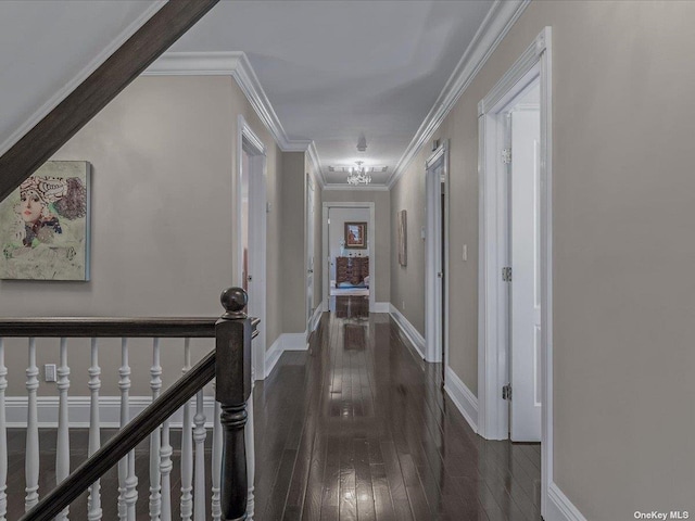 hall featuring ornamental molding, hardwood / wood-style floors, an upstairs landing, and baseboards