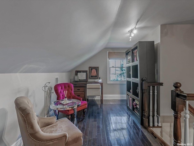 living area with vaulted ceiling, baseboards, and dark wood finished floors