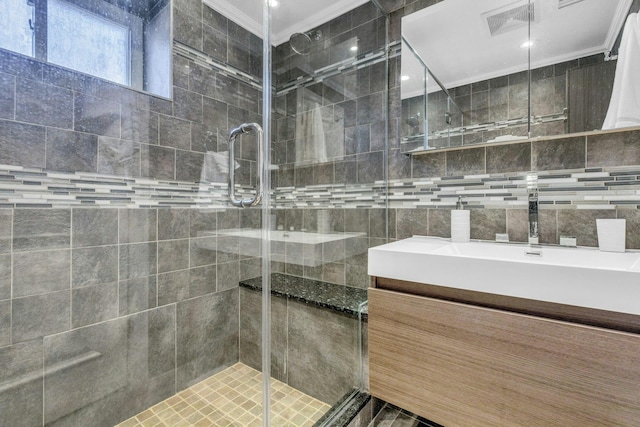 full bathroom featuring ornamental molding, a stall shower, visible vents, and a sink