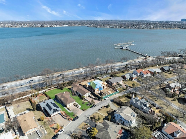 birds eye view of property with a water view and a residential view