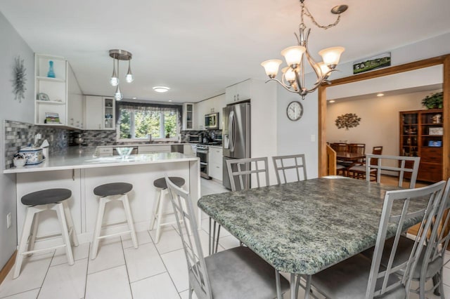 dining space with light tile patterned floors and a notable chandelier