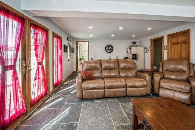 living area with recessed lighting, baseboards, and granite finish floor