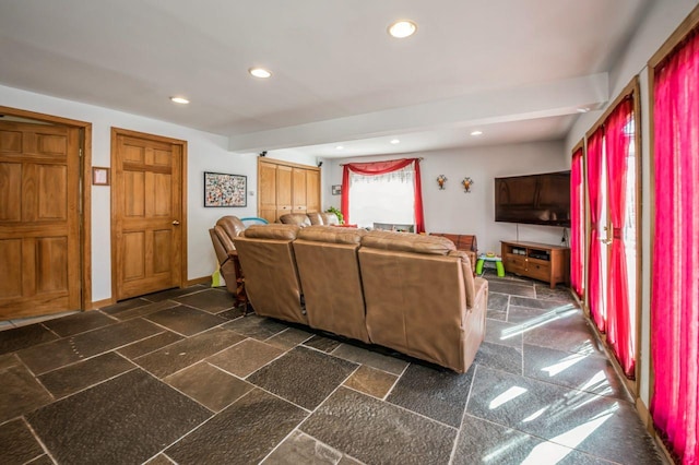 living area featuring recessed lighting, baseboards, and stone tile flooring