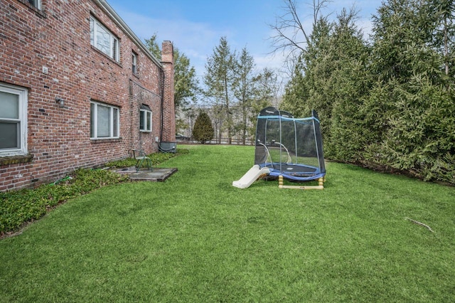 view of yard with a trampoline