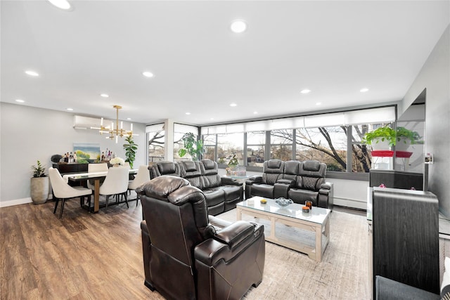 living room with a baseboard radiator, wood finished floors, and recessed lighting