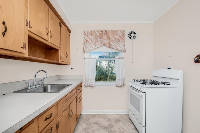 kitchen featuring light countertops, ornamental molding, white gas range oven, and a sink