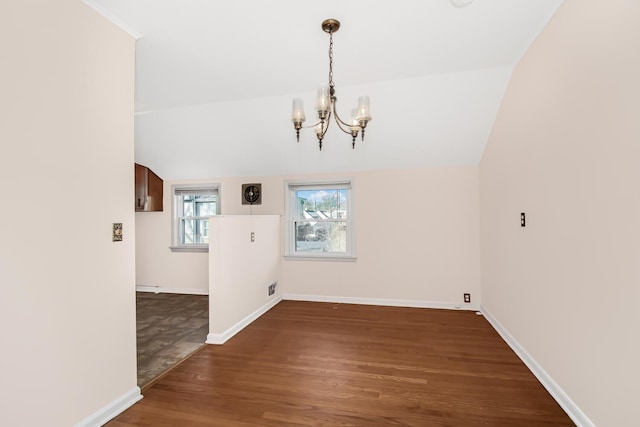 unfurnished dining area with a notable chandelier, visible vents, baseboards, vaulted ceiling, and dark wood finished floors