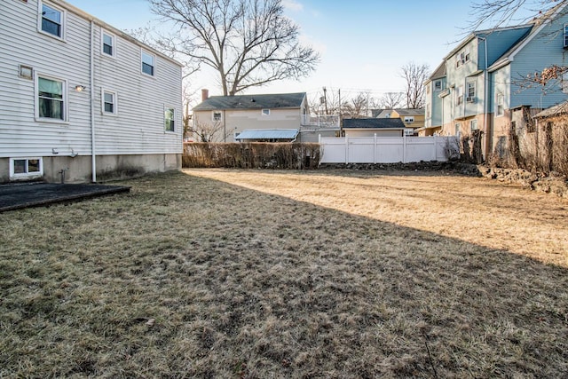 view of yard featuring a residential view and fence