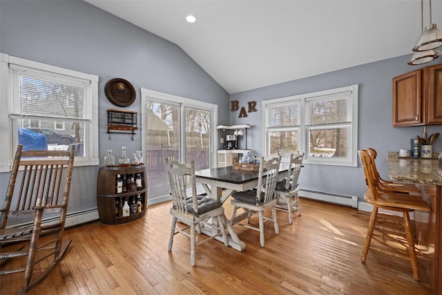 dining area featuring recessed lighting, baseboard heating, a baseboard heating unit, vaulted ceiling, and light wood-type flooring