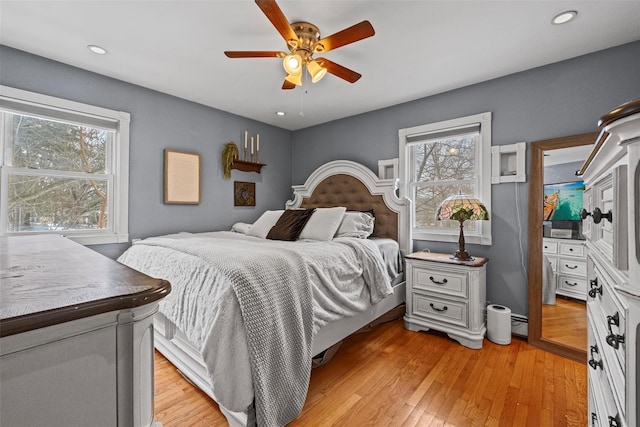 bedroom with recessed lighting, ceiling fan, light wood-style flooring, and a baseboard radiator