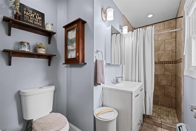 bathroom with toilet, recessed lighting, a baseboard heating unit, vanity, and a tile shower