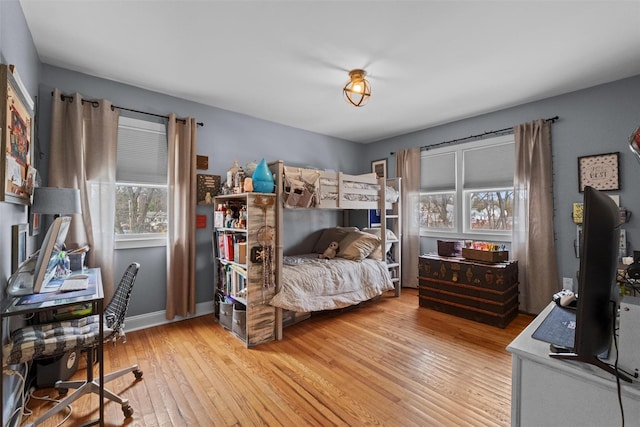 bedroom with light wood-style floors and baseboards