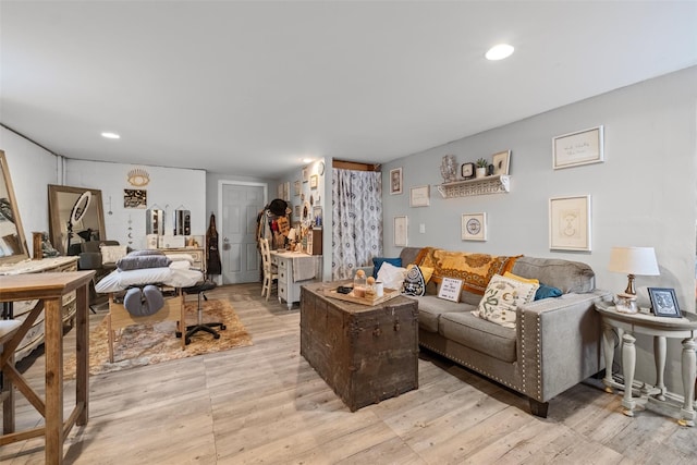 living area with light wood-type flooring and recessed lighting